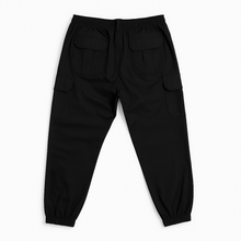 Plus-size male model wearing black twill cotton cargo joggers with side and back pockets