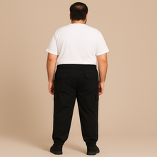 Plus-size male model wearing black twill cotton cargo joggers with side and back pockets