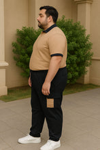 Plus-size Pakistani man wearing a tan and black cargo tracksuit, featuring a polo jersey top and terry pants with side pockets