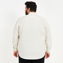 Plus-size Pakistani man wearing off-white formal shirt with black grid checks