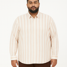 Off-white plus size linen blend shirt with rust and beige vertical stripes, long sleeves – flat lay on wooden background