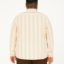 Off-white plus size linen blend shirt with rust and beige vertical stripes, long sleeves – flat lay on wooden background