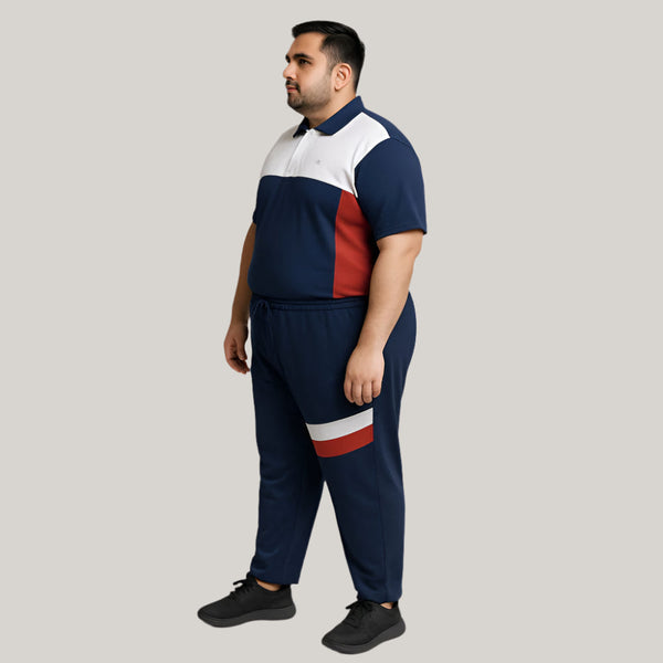 Plus-size man wearing tri-tone navy, white, and red tracksuit – front view, polo shirt and jersey trouser